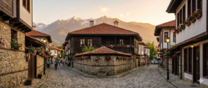 Cobblestone street in the Old Town of Bansko with a view of Pirin Mountain.
