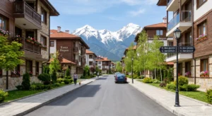 Ivan Djolev Street in the town of Bansko with residential buildings and a beautiful panorama of the Pirin Mountain