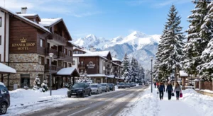 Kralev Dvor Street in Gondola district, Bansko during the winter season with hotels and a view of Pirin Mountain