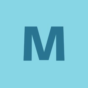 A green container full of wood chips, concrete and other construction waste is located on a construction site. In the background, an unfinished building with open floors and a tall snow-capped mountain are visible under a clear blue sky.