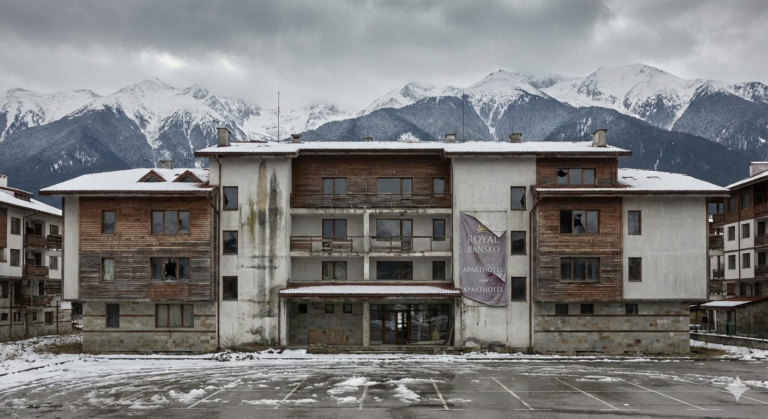 A building with technical problems and leaks in Bansko with the mountain in the background