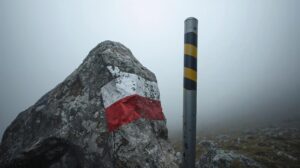 Summer stone strip marking and winter metal stake (stake) in the Pirin Mountains.