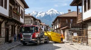 Construction waste container in Bansko in front of a traditional Bulgarian National Revival house