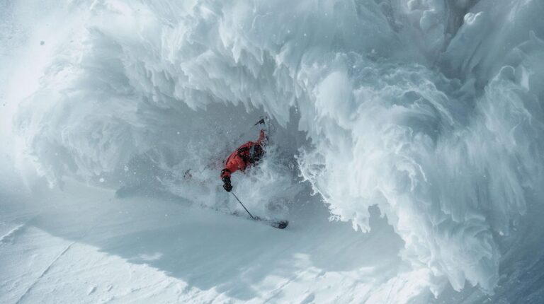 A skier tries to swim out of a falling avalanche using swimming movements