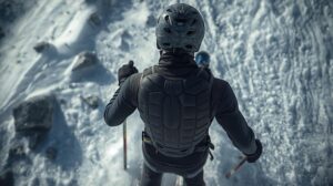 A skier wearing a helmet and back protector on a slope with thin snow and visible rocks.