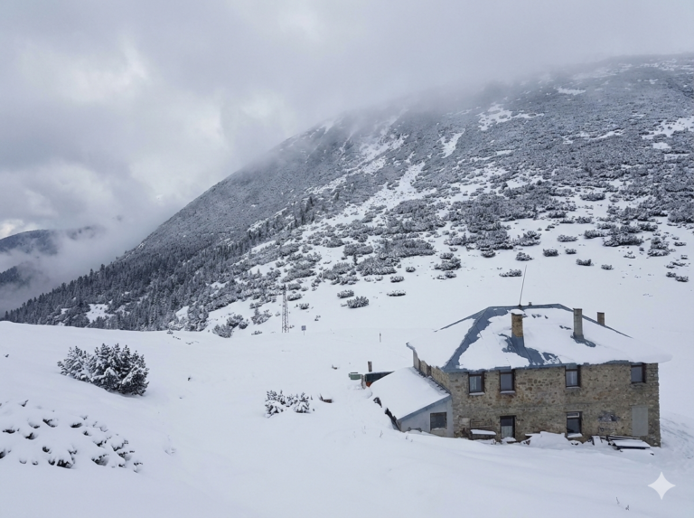The stone building of the Macedonia hut in South Rila, located on the Mechi Prohod saddle below the peaks.