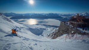 Skiers descend the steep Bezbog Wall slope in front of the people from the hut.