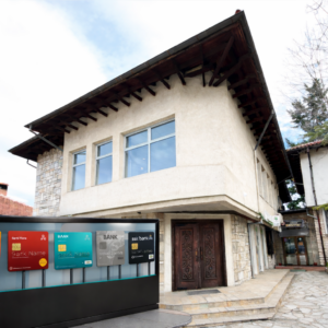 A laptop with financial graphs on a wooden table in a cafe in Bansko, symbolizing the opening of a business bank account.