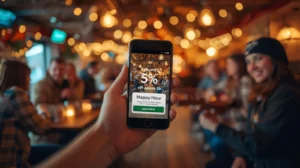 Смартфон, показващ дигитален купон за отстъпка на фона на оживено заведение с жива музика в Банско.